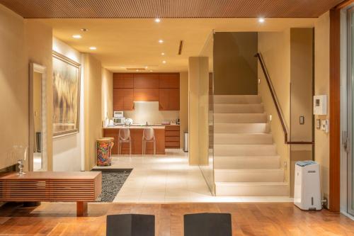 a living room with a staircase in a house at Azabu Modern House The Tokyo Tower can be seen from the villa 500m2 in Tokyo