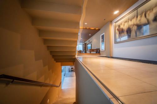 a hallway with a staircase in a house at Azabu Modern House The Tokyo Tower can be seen from the villa 500m2 in Tokyo