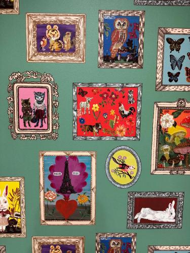 a wall with many pictures of cats in frames at Niseko Purr 101 in Kutchan