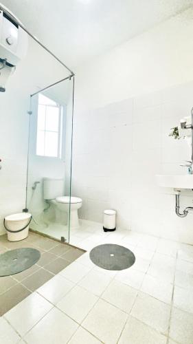 a bathroom with a glass shower and a toilet at Villa LA Lembang Retreat - Bed & Breakfast in Lembang