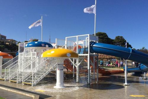 a playground with a water slide in a park at Moonta Bay Stylish large home 3 min walk from beach and jetty in Port Moonta