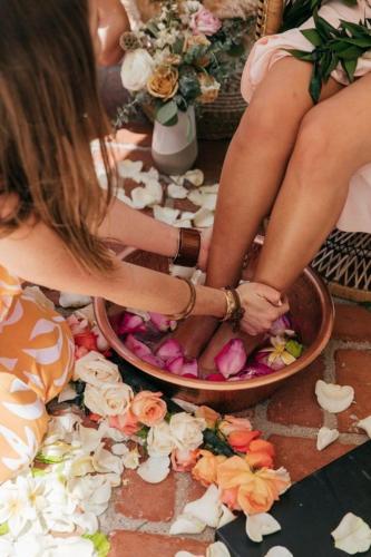 a woman sitting in a bowl filled with flowers at Bantique Hotel in Da Nang