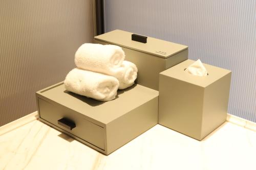two boxes with towels sitting on top of them at Doubletree By Hilton Rugao in Rugao