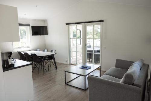 a living room with a couch and a table at Halens Camping och Stugby in Olofström