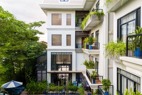 an apartment building with balconies and plants at Bayon Modern Residence in Siem Reap