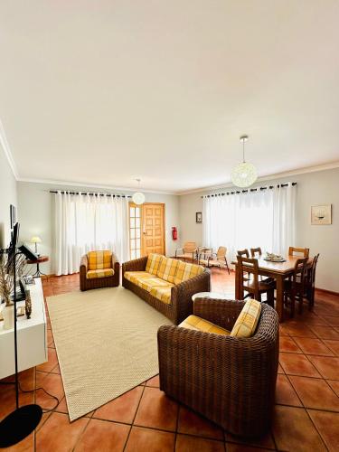 a living room with couches and a dining room at Quinta do Ribeiro Salgado's Beach House in Porto Santo
