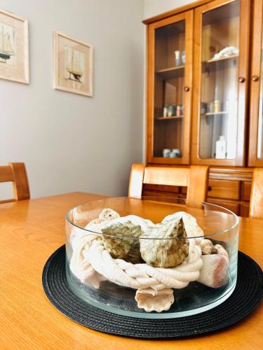 a glass bowl filled with shells on a table at Quinta do Ribeiro Salgado's Beach House in Porto Santo