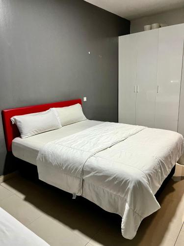 a bedroom with a large bed with a red headboard at Hostal Gracias in Madrid