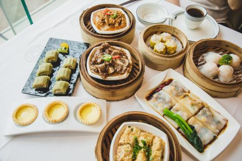 a table with many different types of food in wooden bowls at Yufei high-altitude night view Huge-Screen Audiovisual Hotel-Guangzhou Tower Zhujiang New Town Sports West Road Branch in Guangzhou
