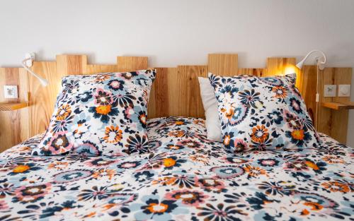 a bed with two pillows on top of it at Appartement au coeur des Pyrénées in Argelès-Gazost