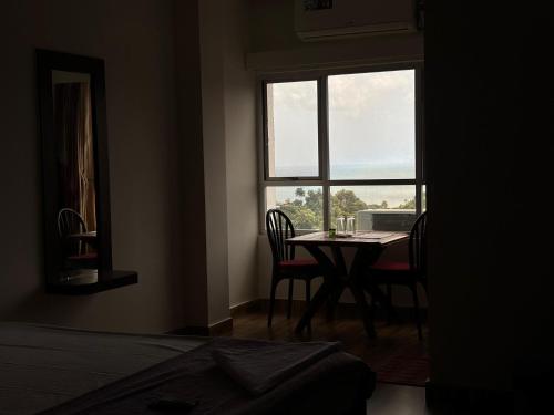 a room with a table and chairs and a window at The Tamarind Tree Hotel & Restaurant in Shādipur