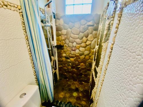 a bathroom with a shower with a mosaic shower curtain at LADY GHAGHA ROOM RENTALs in San Vicente
