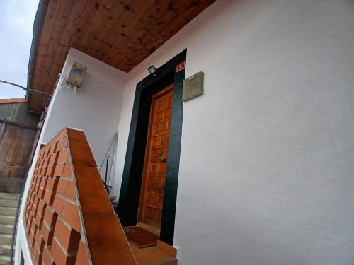 a door on the side of a building at La casa del patio in La Arboleda