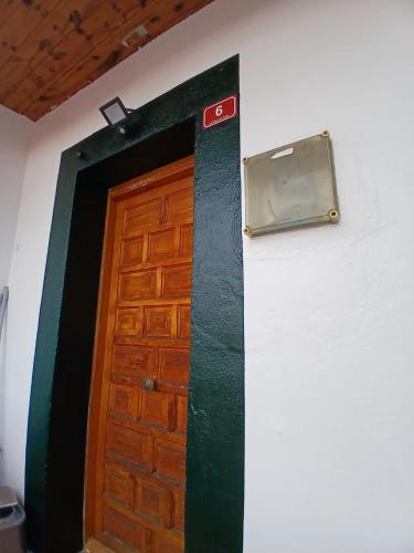 a door in a room with a sign on the wall at La casa del patio in La Arboleda
