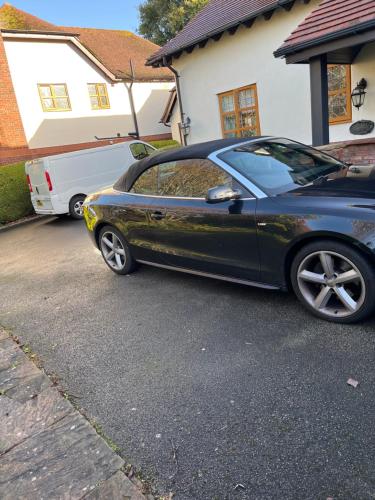 a car parked in the driveway of a house at Sharons Retreat your own private lounge bedroom Bathroom and the use of a hot tub I also live here in Prestatyn