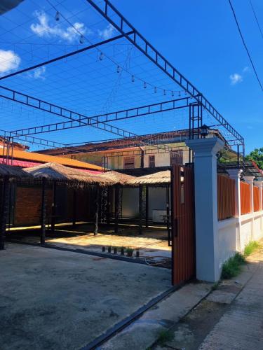 a building with a metal roof on a street at Venn Hostel in Vientiane
