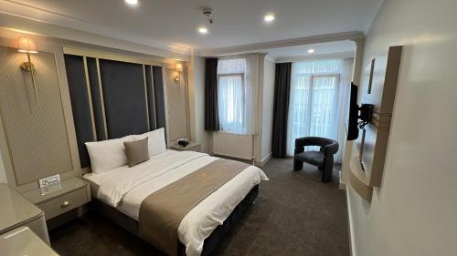 a hotel room with a bed and a chair at Espoir HOTEL in Istanbul