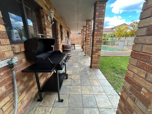a barbecue grill on the side of a house at Spacious Ocean View Home in Noraville in Norah Head