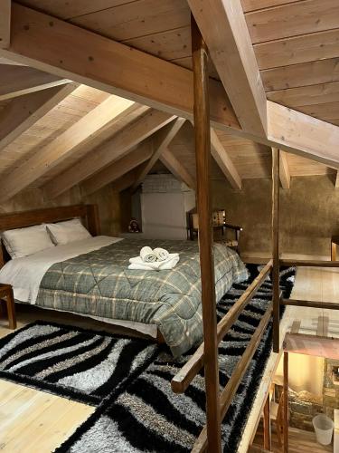 a bedroom with a bed in an attic at Το Στέκι in Arachova