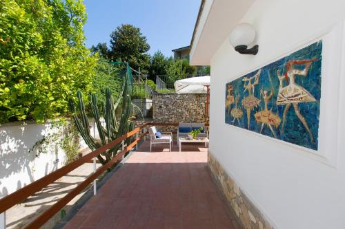 a patio with a mural on the side of a house at Appartamento in Villa con Terrazzo e Vista Golfo in Massa Lubrense