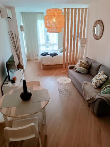 a living room with a couch and a table at Estudio MELMAR en Playamar in Torremolinos