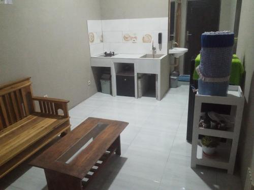 a room with a kitchen with a sink and a table at Surya homestay in Batukaras