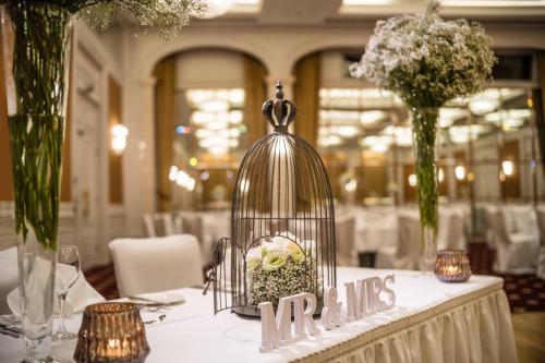 a bird in a bird cage on a table at Le Méridien Stuttgart in Stuttgart