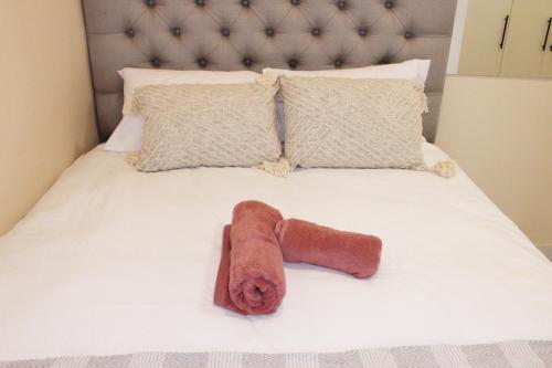 a towel laying on top of a bed at 55 New Street, Makhanda in Grahamstown