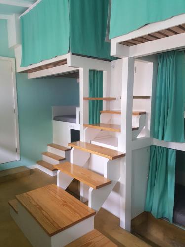 a room with bunk beds and a staircase at Conde Surf Camp - Capsule Beds FEMALE Dorm in Vila do Conde