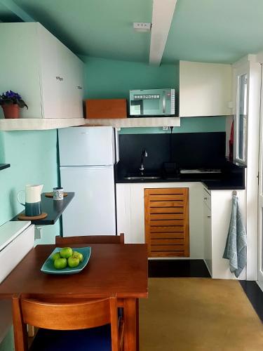 a kitchen with a plate of fruit on a table at Conde Surf Camp - Capsule Beds FEMALE Dorm in Vila do Conde