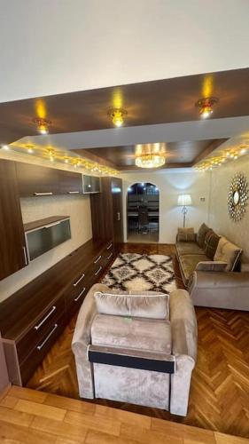 a living room with a couch and a tv at Bella space in Suceava