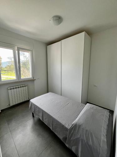 Ένα ή περισσότερα κρεβάτια σε δωμάτιο στο Casa confort a due passi dal mare
