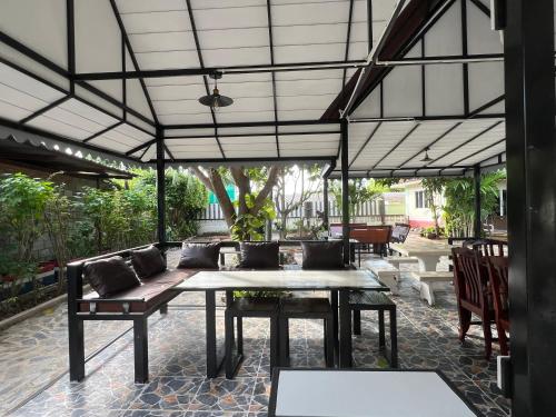 an outdoor patio with a table and chairs at Suanpai Resort Sattahip in Sattahip