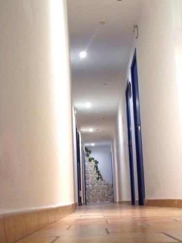 a hallway of a building with a stone wall at Hotel Du Lac in Château-Arnoux-Saint-Auban