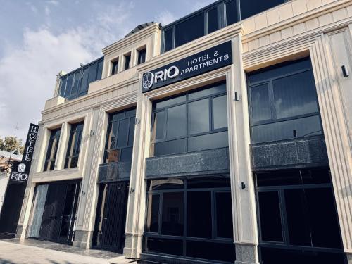 a building with a sign on the front of it at RIO Hotel in Samarkand