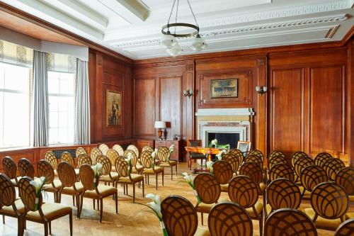 a room with chairs and a table and a fireplace at London Marriott Hotel County Hall in London