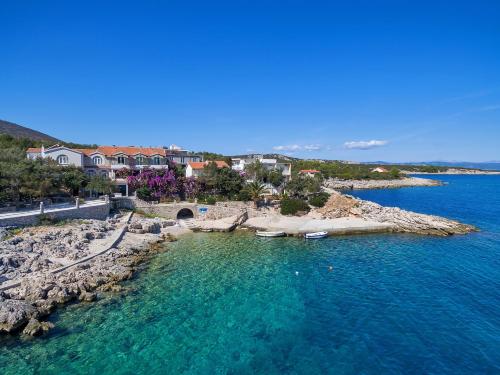 an aerial view of a beach with boats in the water at Apartmani Nikola in Zastražišće