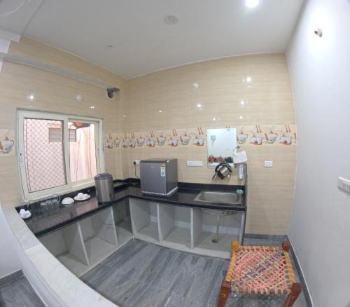 a small kitchen with a sink and a window at CHOUDHARY WHITE HOUSE Udaipur in Udaipur
