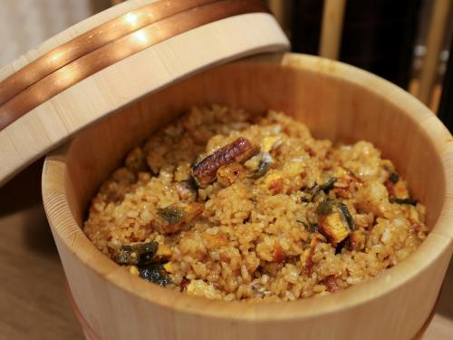 a wooden bowl of food withinoa and vegetables at Dormy Inn Tsu in Tsu