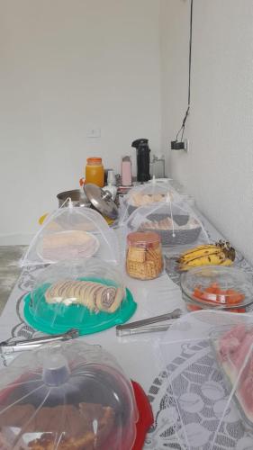 a table with plates and bowls on top of it at Pousada Flor da Barra in Maragogi