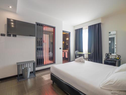 a bedroom with a large bed and a large window at San Valentino Hotel in Villa di Serio