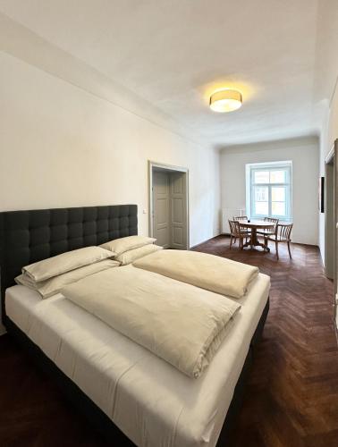 a bedroom with a large bed and a table at Altstadt Idylle Bad Radkersburg in Bad Radkersburg