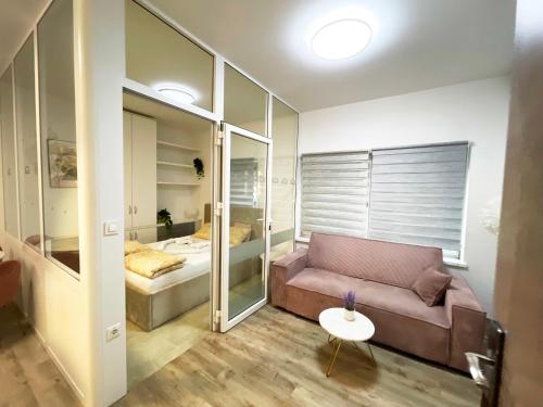 a living room with a couch and a bed at The Maze Apartment in Ljubljana