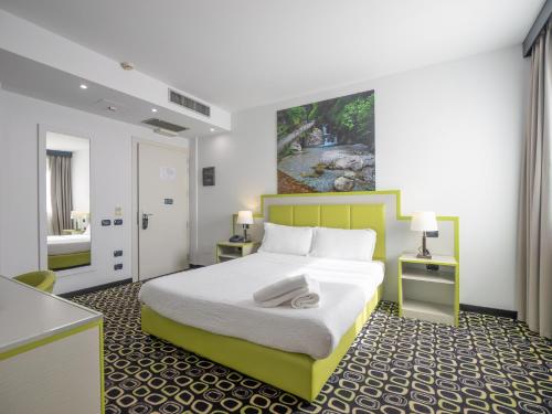 a hotel room with a bed and a kitchen at San Valentino Hotel in Villa di Serio
