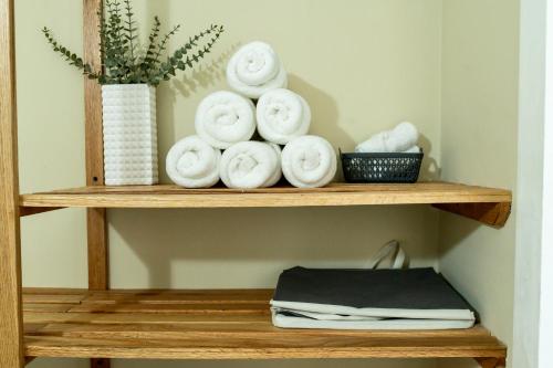 a wooden shelf with towels and a vase on it at Falcon Breeze-Gated-Security-Airport Pickup Available in Montego Bay