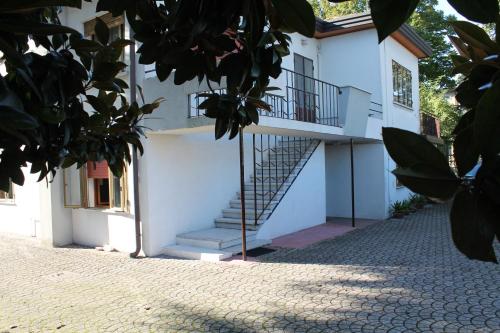 a white building with stairs on the side of it at Appartamento Le Magnolie in Mestre