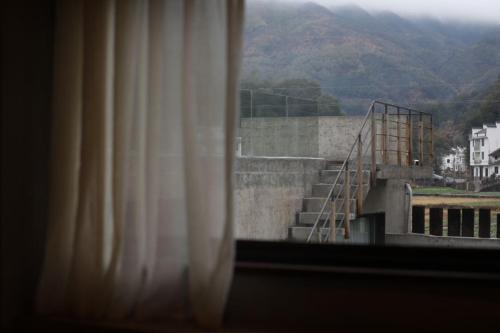 a view of a stair case from a window at Wuyuan On The Bound Hotel-婺源水岸边民宿 in Jianlingjue