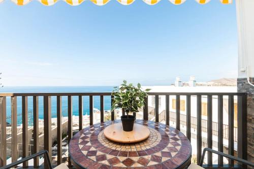 a table with a potted plant on a balcony at Almodo Suite Patalavaca in Patalavaca