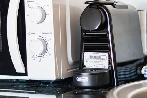 a cell phone sitting on a counter next to a microwave at Almodo Suite Patalavaca in Patalavaca