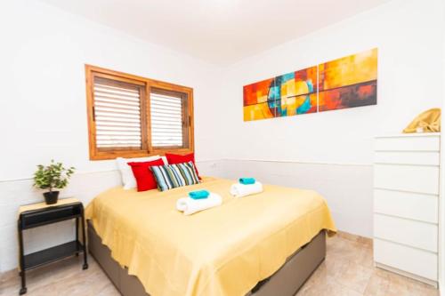 a bedroom with a bed with two towels on it at Almodo Suite Patalavaca in Patalavaca